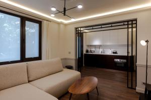 a living room with a couch and a kitchen at Private Premium Apartment in Plovdiv in Plovdiv