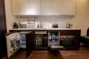 a kitchen with an open refrigerator and a counter at Private Premium Apartment in Plovdiv in Plovdiv +23 photos