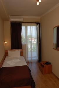 Postel nebo postele na pokoji v ubytování Hotel Liliacul