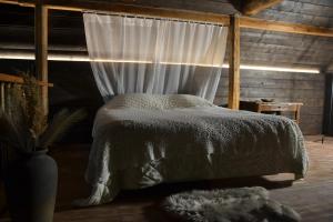 a bedroom with a bed with a canopy and a window at Wallilan Yliset in Äänekoski