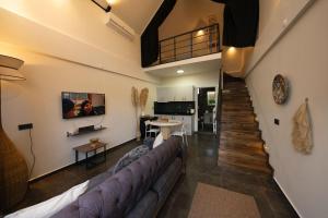 a living room with a couch and a staircase at Monk Living Space in Kocaeli