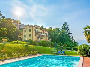 a swimming pool in front of a house at Residenza Verde Lago in Stresa