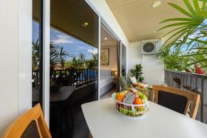 a bowl of fruit on a table on a balcony at The Terraza Studio A303 in Amphoe Koh Samui