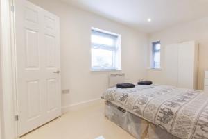 a bedroom with a bed and a white door at Radstock Road - Room 2a in Southampton