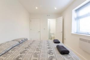 a bedroom with a bed with two towels on it at Radstock Road - Room 2a in Southampton