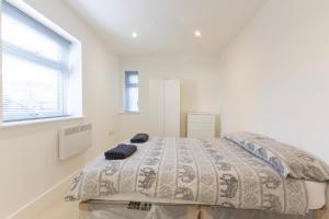 a bedroom with a bed in a white room at Radstock Road - Room 2a in Southampton