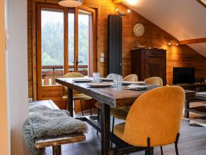 a dining room with a table and chairs at Sapinette in Arâches-la-Frasse