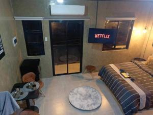 a bedroom with a bed and a sign that reads netflix at Casa Karina in Camp Wilhelm