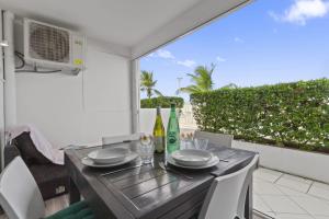 a table with two bottles of wine on a balcony at Marigot Bay in Saint Martin