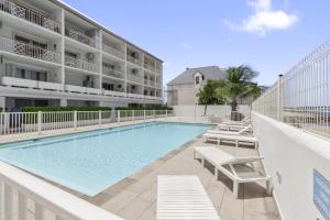a swimming pool with chaise lounge chairs next to a building at Marigot Bay in Saint Martin
