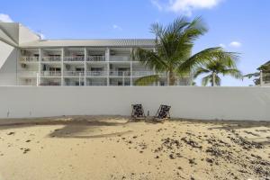 a building on the beach with two chairs in front of it at Marigot Bay in Saint Martin