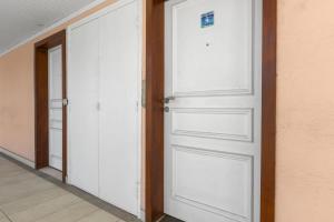 an open white door in a room with a hallway at Marigot Bay in Saint Martin +6 photos