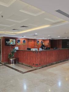 a lobby with a person sitting at a desk at Crown Tower Hotel in Al Jubail +28 photos