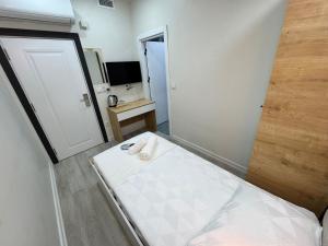a small room with a bed and a mirror at QLİNE HOTEL AİRPORT SaW in Istanbul +35 photos