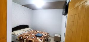 a bedroom with a bed in a white room at Departamento jaspe in Cajamarca