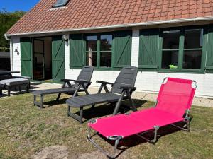 a group of chairs sitting in front of a building at Maison Duinendaele 101 - De Panne in De Panne