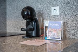 a hair drier on a counter next to a book at GuestReady – Urban comfort in Vila Nova de Gaia in Vila Nova de Gaia +25 photos