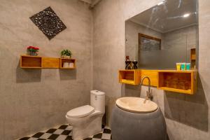 a bathroom with a toilet and a sink and a mirror at Angkor Rithy Residence in Siem Reap +31 photos