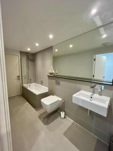 a bathroom with a toilet and a sink and a mirror at 6 Ocean Gate apartment in Newquay +11 photos