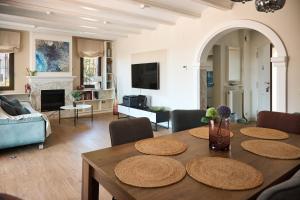 a living room with a table with chairs and a couch at THE BEST HOLIDAY VILLA in Calpe