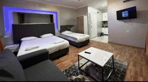 a hotel room with two beds and a couch at Link Taksim Hotel in Istanbul