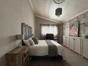 a bedroom with a large bed with a wooden table at StruisHuis in Struisbaai +13 photos