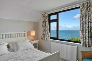 a bedroom with a bed and a large window at Finest Retreats - Michel in Carbis Bay