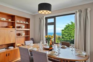 a dining room with a table and a large window at Finest Retreats - Michel in Carbis Bay