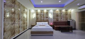 a hotel room with a bed and a couch at VENTURA Boutique Residence in Pattaya Central +81 photos