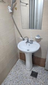 a bathroom with a white sink and a mirror at Time Stay in Busan