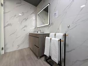 a bathroom with marble walls and a sink and towels at Flôr do Távora in Vila da Ponte +36 photos