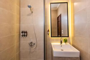 a bathroom with a sink and a shower with a mirror at Travelholic Residence Near Mivida in Cairo +44 photos
