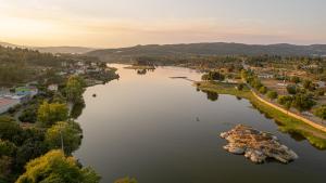 an aerial view of a river with a town at Flôr do Távora in Vila da Ponte