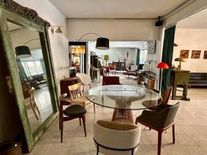 a living room with a glass table and chairs at Cozy Family Homestay 2BR with Balcony in Shared Bungalow SS2 PJ in Petaling Jaya