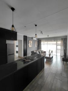 a large kitchen with a large island in a living room at Mama R's unit 39 in Newcastle