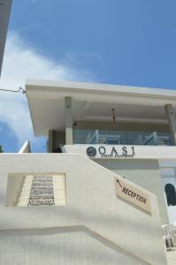 a white house with a sign on the side of it at Oasi Luxury Apartments in Glífa