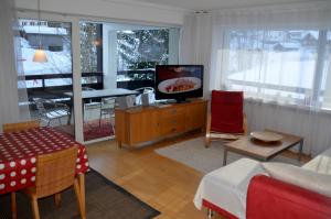 a living room with a television and a dining room at Haus Bruegge in Mellau