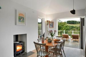 una sala da pranzo con tavolo e camino di Finest Retreats - Three Quarter Cottage a Fowey