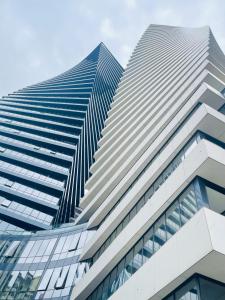 a tall office building with glass windows at New Stylish 1 BR apartment in Axis Towers in Tbilisi City