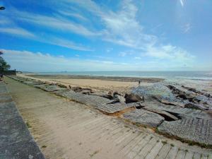 a rock wall on a beach next to the ocean at gite notre désir 100 m de la mer in Jullouville-les-Pins