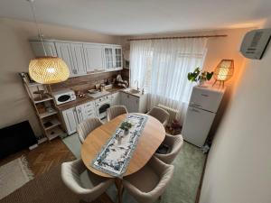 a kitchen with a table and chairs in a room at Lovely cozy vintage apartment in Kyustendil