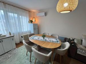 a dining room with a table and chairs at Lovely cozy vintage apartment in Kyustendil