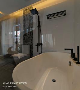 a large white bath tub in a bathroom at Q3 Inn in Semporna +27 photos