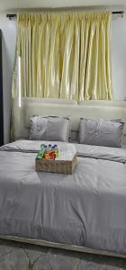 a bed with a basket of toys on top of it at Winters Apartments in Abuja
