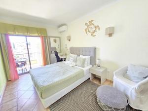 a bedroom with a bed and a table with a chair at Dream Lagos B&B in Lagos