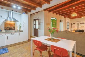 a kitchen and dining room with a white table and chairs at Loft B2, Apartment in Seville in Seville