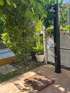 a garden with a tree and a fence with plants at Kaly Mare Sithonia in Kalyves Poligirou