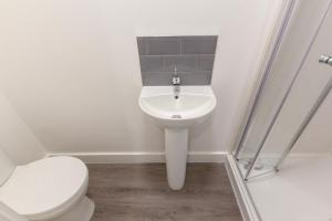 a bathroom with a toilet and a sink at Radstock Road - Room 3a in Southampton