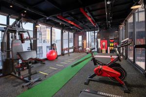 a gym with exercise equipment in a building at Paon Boutique Hotel & Spa in Hanoi
