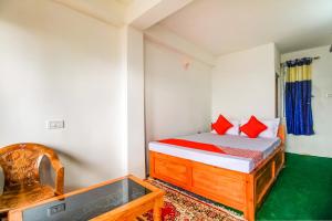 a bedroom with a bed with red pillows at Hotel O Uzen Homestay in Lachung